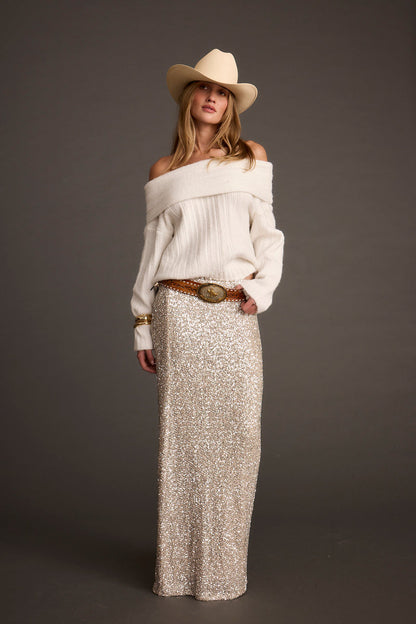 Back view of the ivory sweater showing the silhouette and fit.