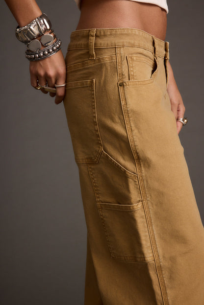 Full-length view of the khaki pants showing the drape and movement.