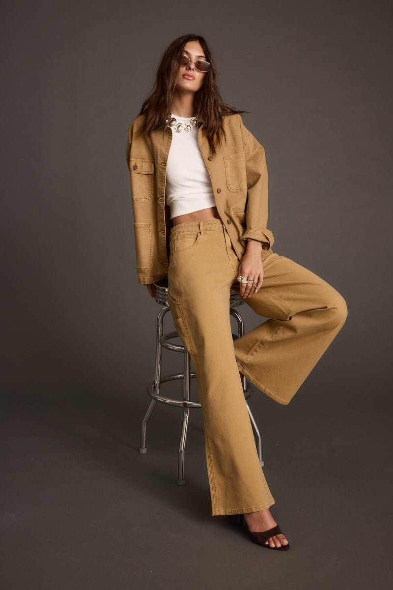 Lifestyle shot of the khaki pants styled for day-to-night versatility.