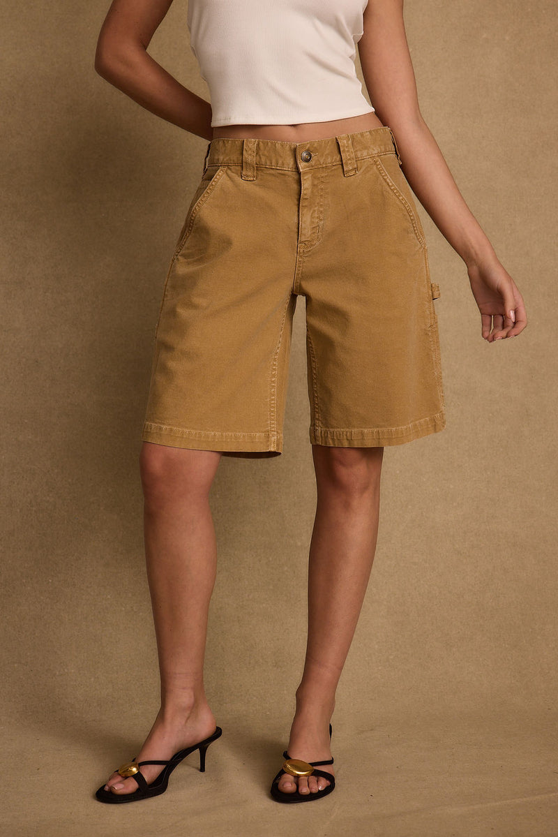 Lifestyle shot of the khaki shorts styled for day-to-night versatility.