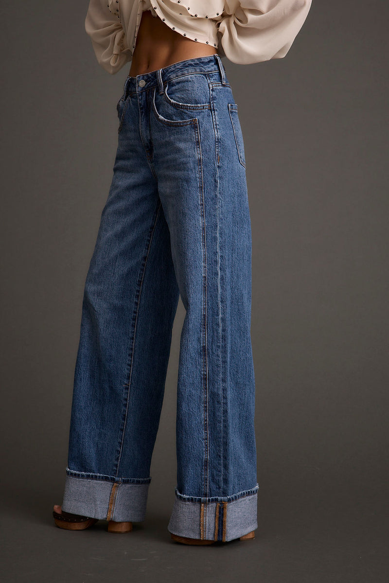 Back view of the denim pants showing the silhouette and fit.