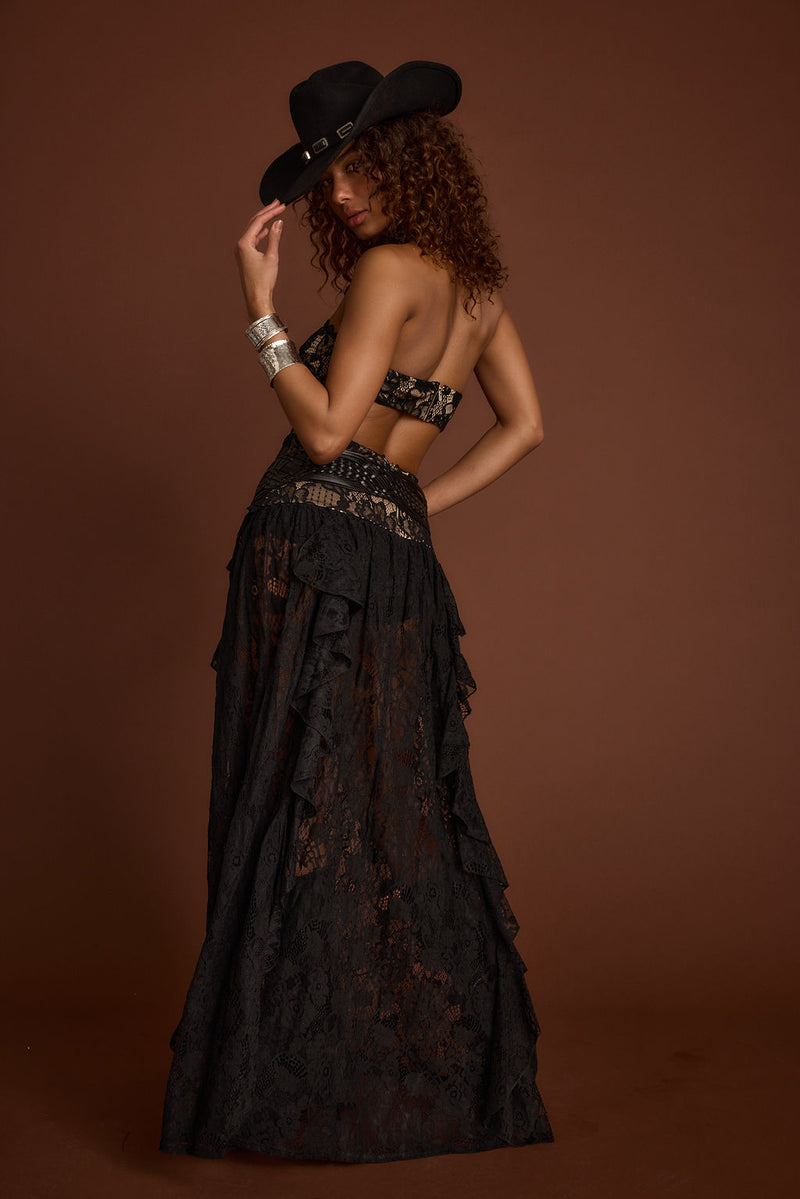 Lifestyle shot of the black maxi dress styled for day-to-night versatility.