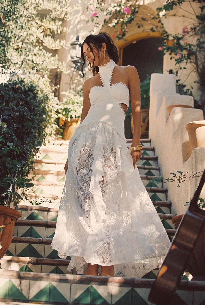 Full-length view of the white maxi dress showing the drape and movement.