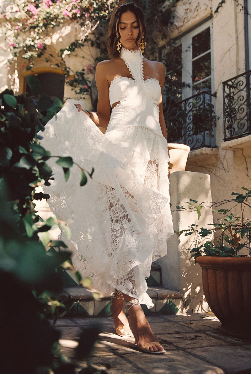 Lifestyle shot of the white maxi dress styled for day-to-night versatility.