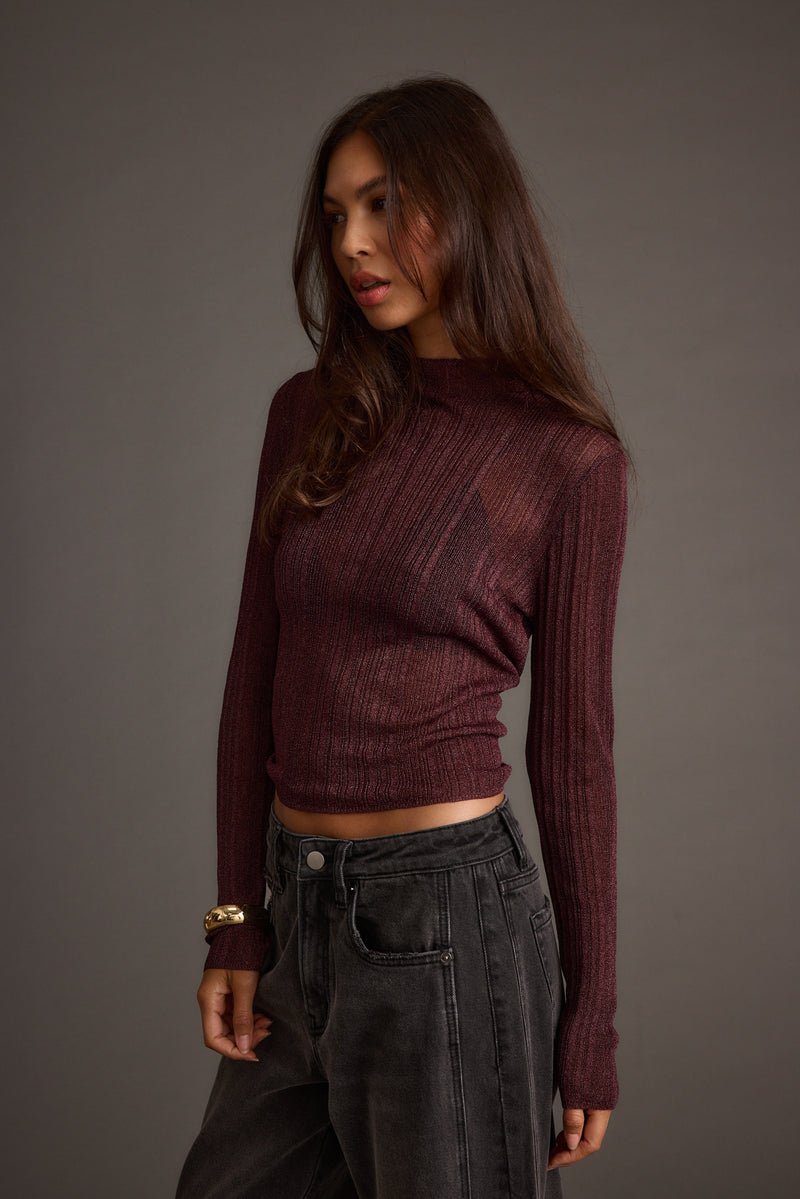 Detail shot of the Rania Mulberry Mock Neck Top highlighting the design elements.