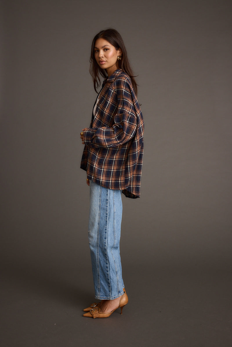 Full-length view of the navy piece showing the drape and movement.