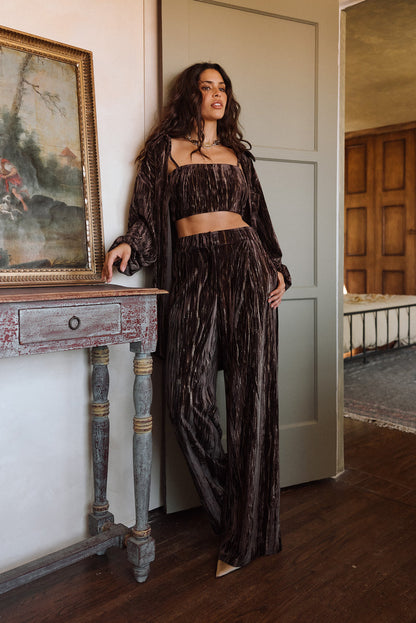 Full-length view of the espresso trousers showing the drape and movement.