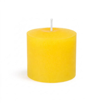 An unlit Yellow unscented votive candle isolated on a solid white background