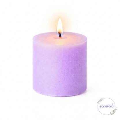 A lit lavender scented candle and a small round logo badge on white