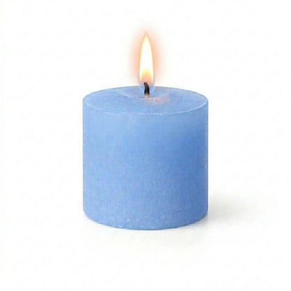A lit blue candle styled with Frosted Votive Holders on a white background