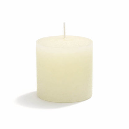 Close-up of an unlit white candle pillar with a cotton wick