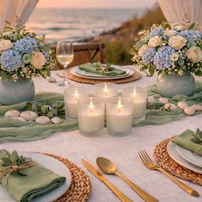 Elegant beach wedding table centerpiece with ivory candles inside clear Frosted Votive Holders