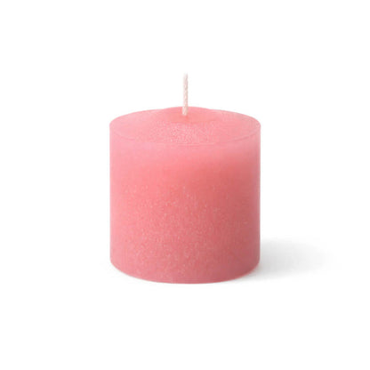 Pink votive candle isolated on a white background