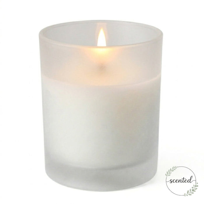 Lit citronella scented white candle in a frosted holder on a white background with a scented logo