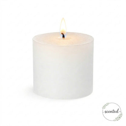 A single lit white citronella scented pillar candle