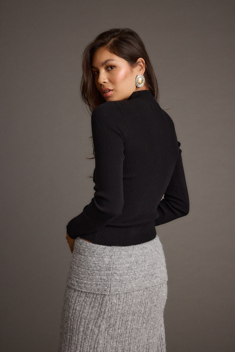 Back view of the black piece showing the silhouette and fit.