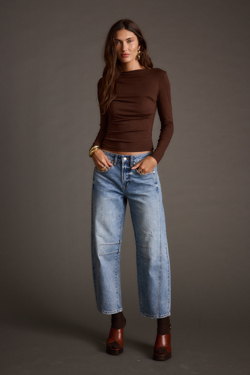 Lifestyle shot of the espresso top styled for day-to-night versatility.