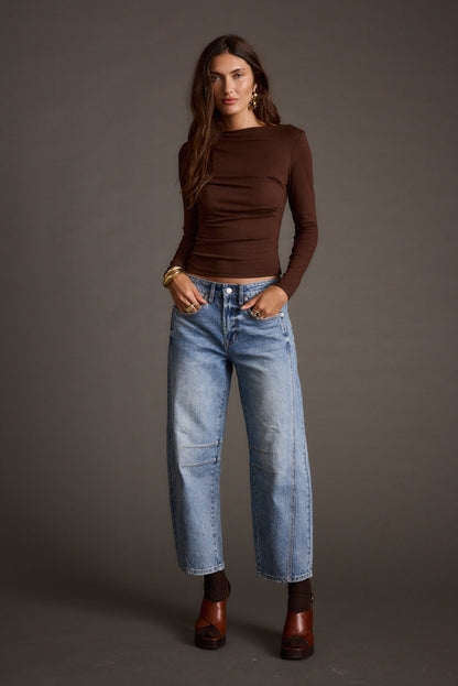 Lifestyle shot of the espresso top styled for day-to-night versatility.