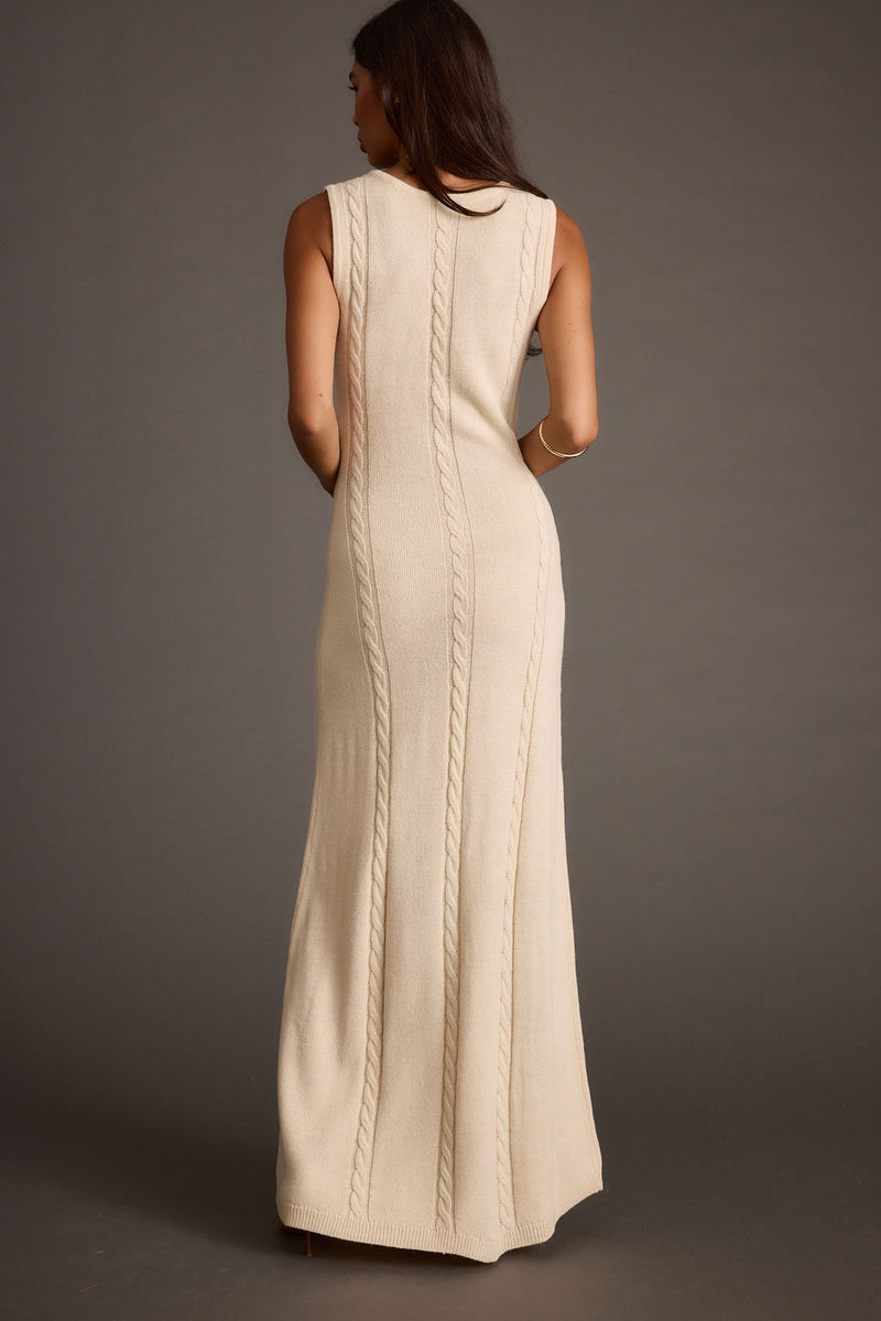 Full-length view of the cream maxi dress showing the drape and movement.