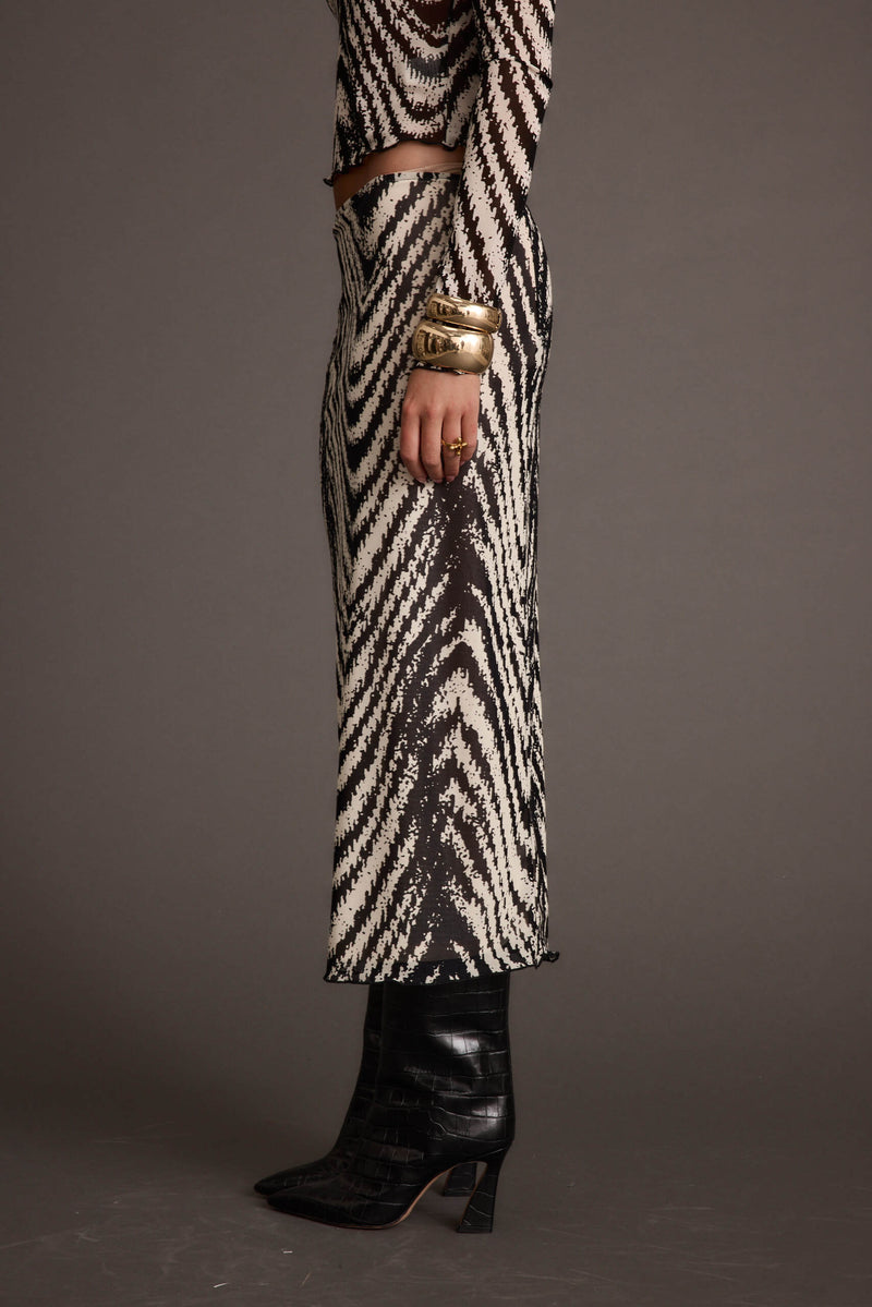 Lifestyle shot of the gold piece styled for day-to-night versatility.