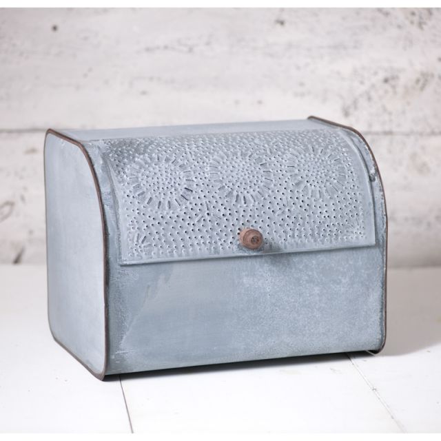 Weathered zinc bread box with punched-tin lid, offering farmhouse charm and aeration for bread on a tidy countertop.