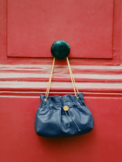 ANISETTE denim-effect leather small bucket bag, lifestyle setting by Rouje