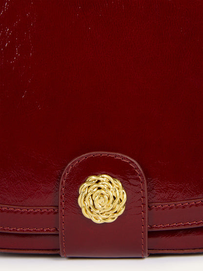 TROQUET burgundy patent leather bag, detail of gold R logo by Rouje