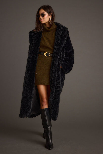 Black jacket with refined detailing and a flattering silhouette.