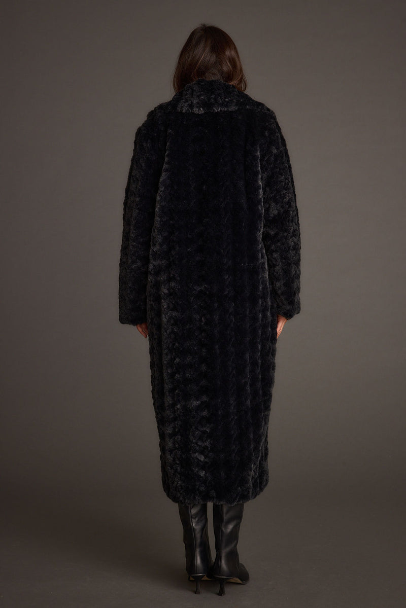 Back view of the black jacket showing the silhouette and fit.