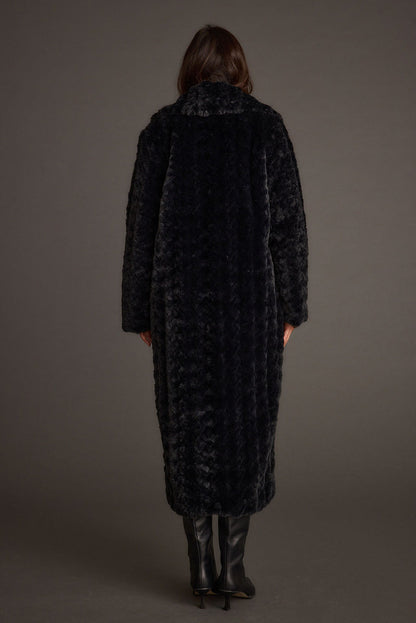 Back view of the black jacket showing the silhouette and fit.