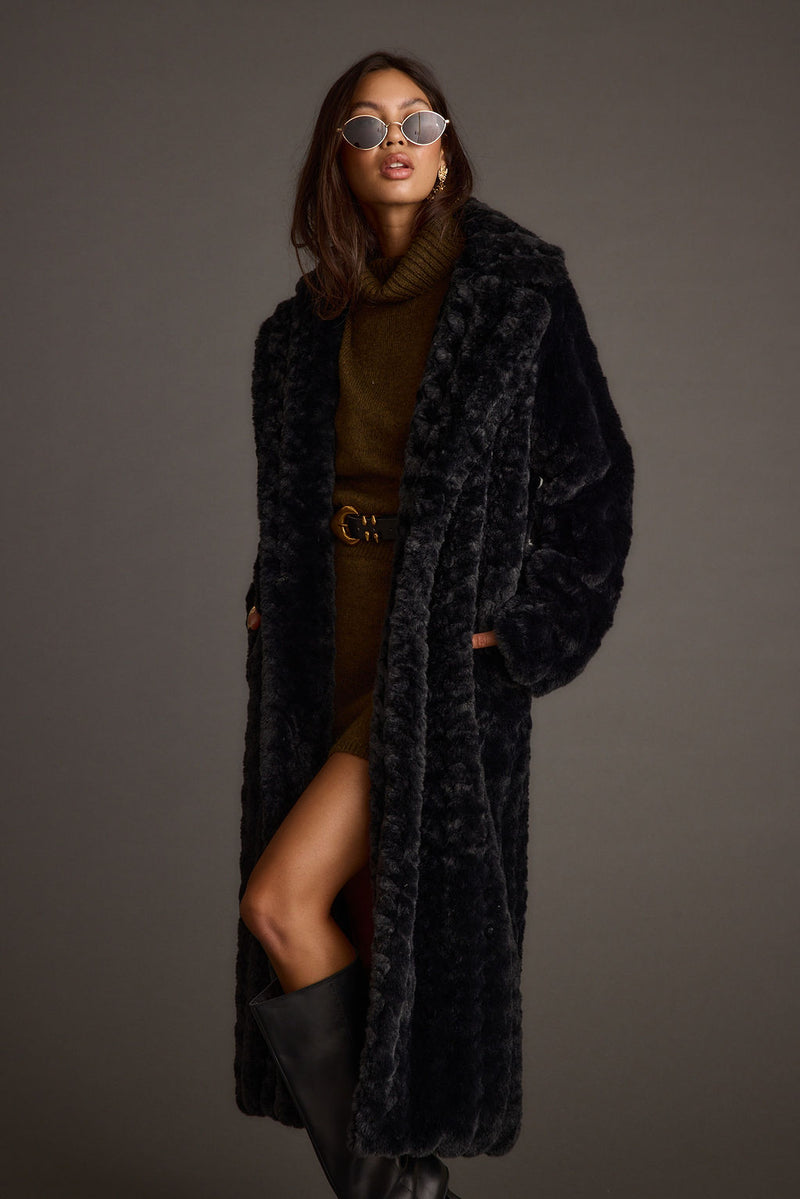 Close-up of the Sasha Black Floor Length Coat showcasing the fabric texture and design details.