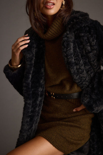 Full-length view of the black jacket showing the drape and movement.