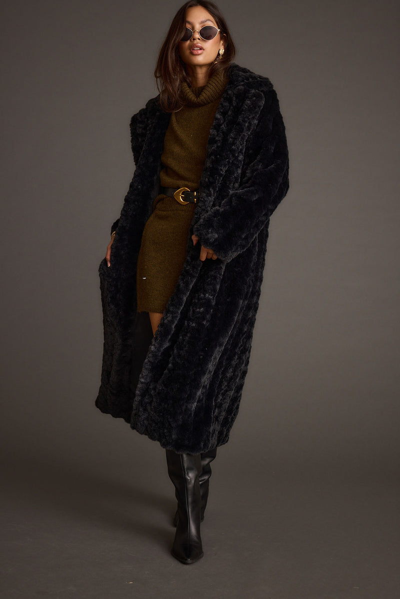 Lifestyle shot of the black jacket styled for day-to-night versatility.