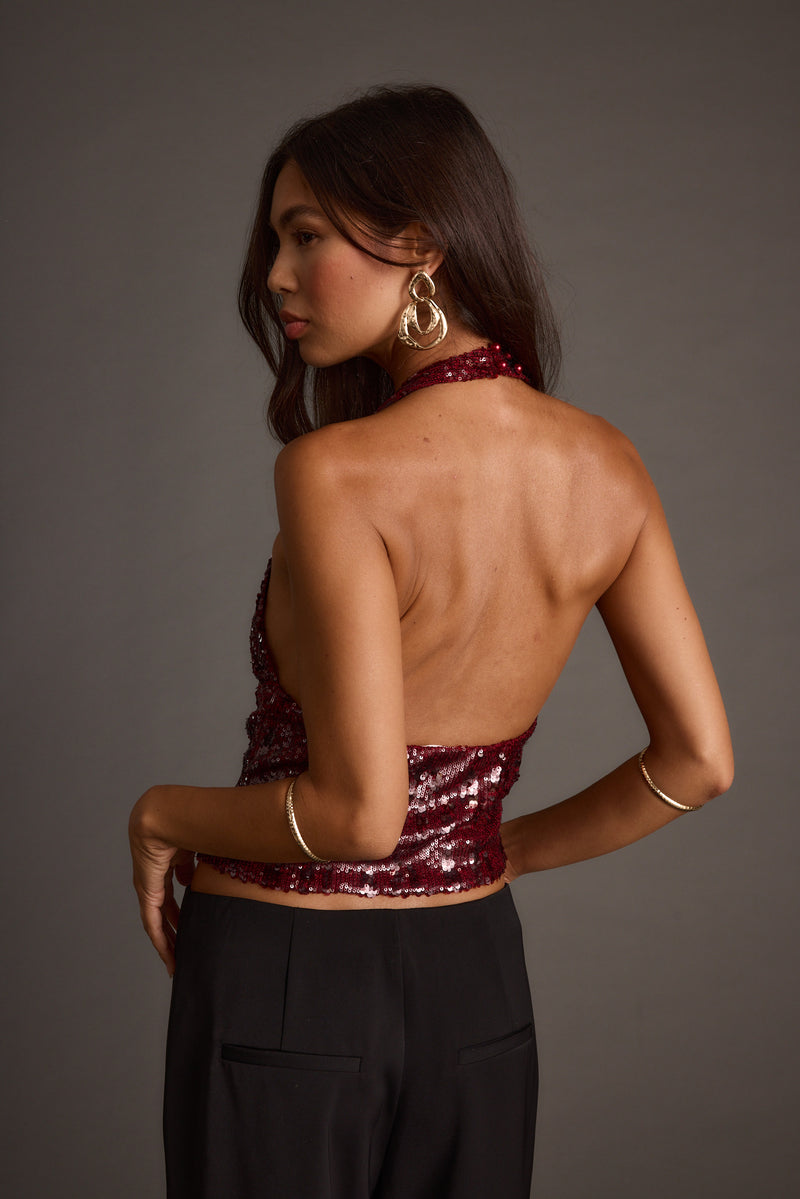 Back view of the sequin halter top showing the silhouette and fit.
