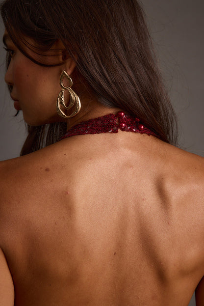 Selena Mulberry Sequin Halter Top shown in a complementary styling arrangement.