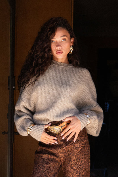 Full-length view of the sweater showing the drape and movement.