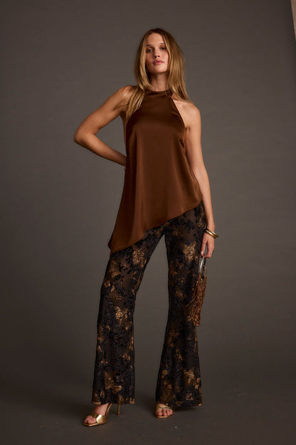 Full-length view of the black flare pants showing the drape and movement.