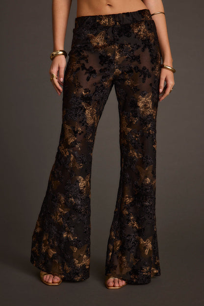 Blaise Black and Gold Mid Rise Flare Pants paired with complementary accessories for a polished look.
