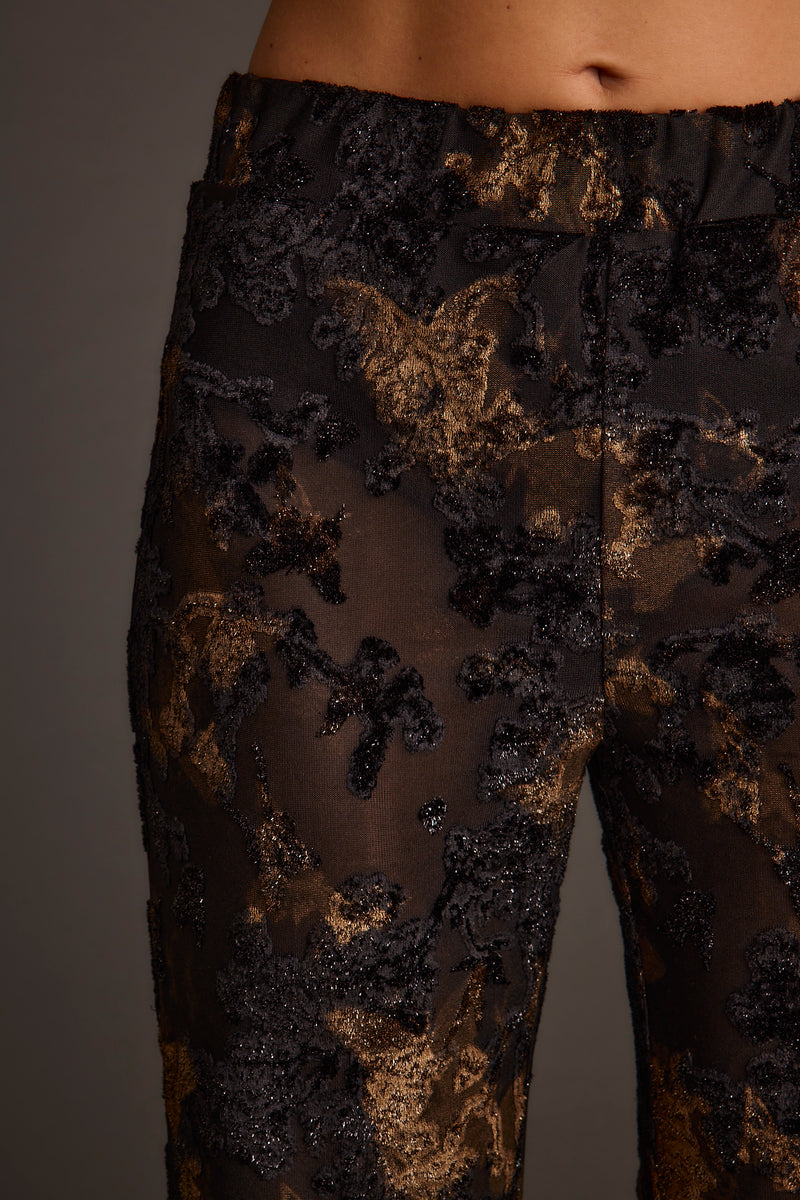Blaise Black and Gold Mid Rise Flare Pants styled in a complete look from an alternate angle.