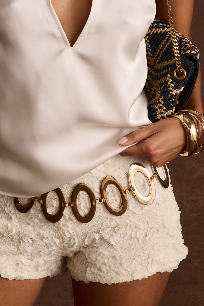 Gold belt with refined detailing and a flattering silhouette.