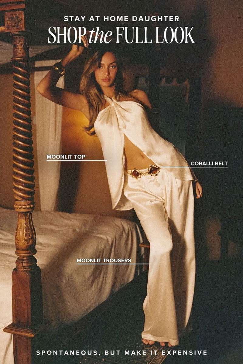 White piece with refined detailing and a flattering silhouette.