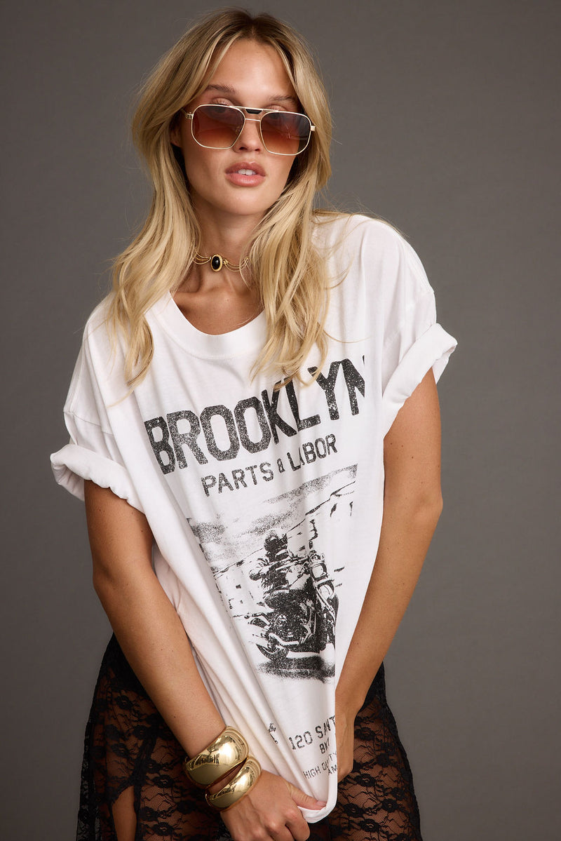White piece with refined detailing and a flattering silhouette.