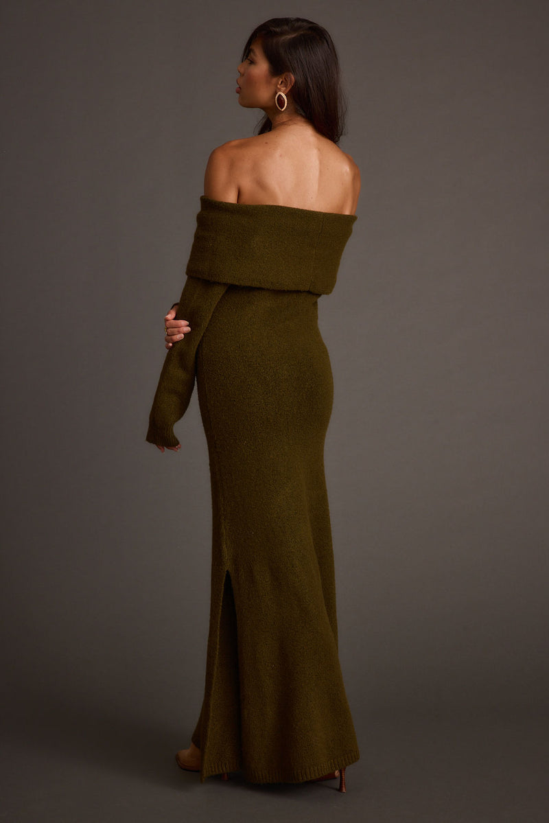 Full-length view of the olive maxi dress showing the drape and movement.