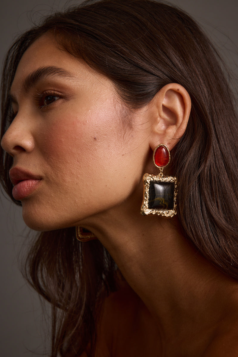 Close-up of the Soleil Statement Earrings showcasing the metalwork and pendant detail.