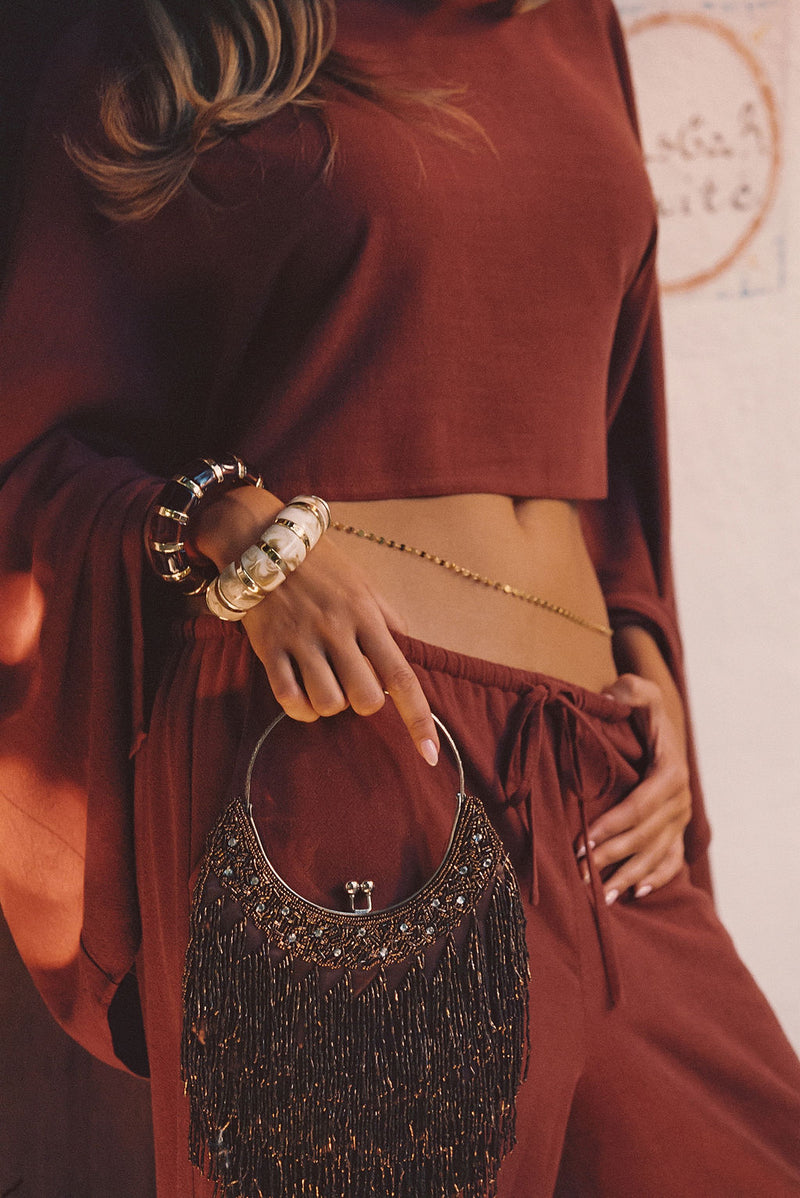 Back view of the gold piece showing the silhouette and fit.
