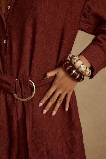 Full-length view of the gold piece showing the drape and movement.