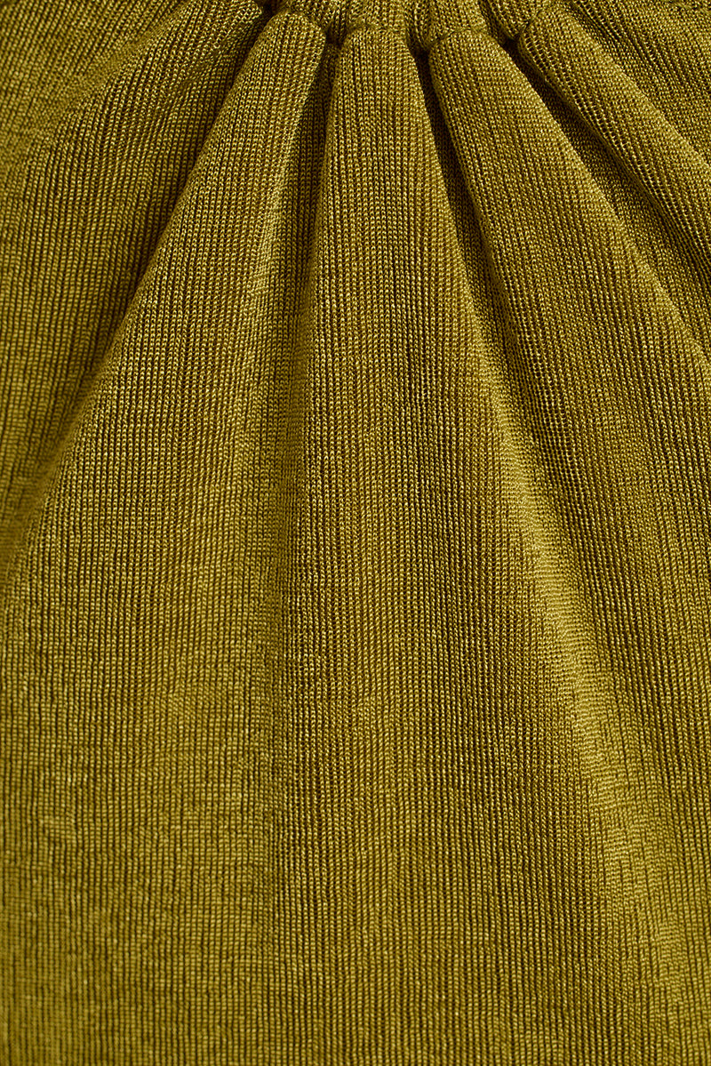 Close-up of chartreuse green knit fabric with gathered ruching on the Sunspell maxi dress.