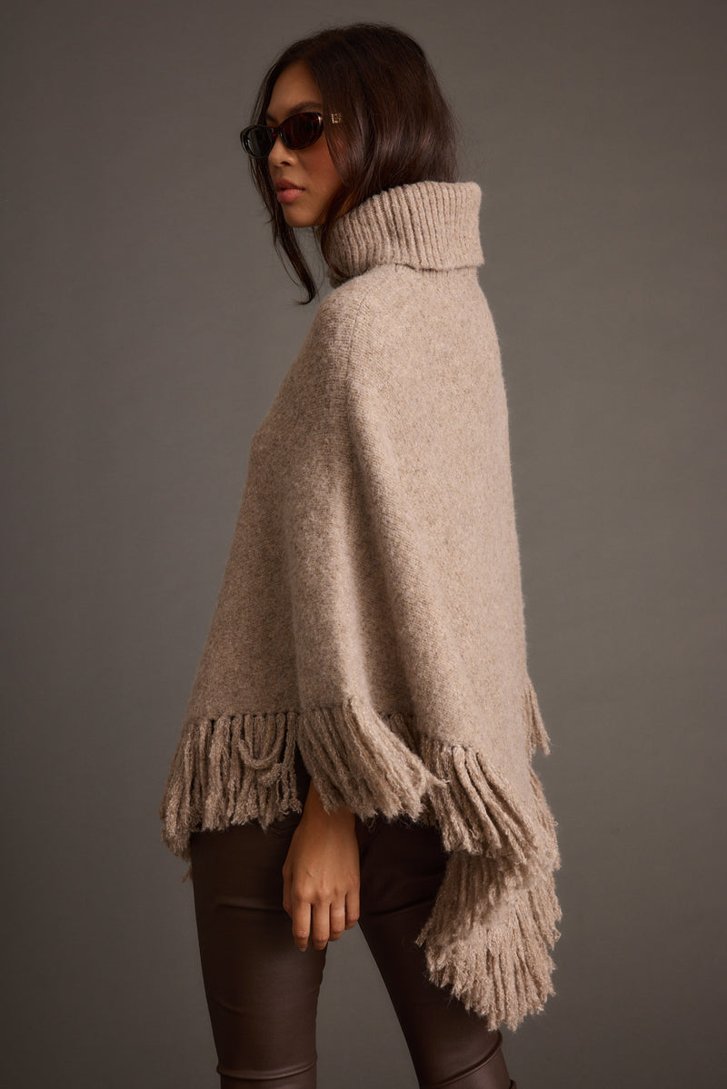 Full-length view of the sweater showing the drape and movement.