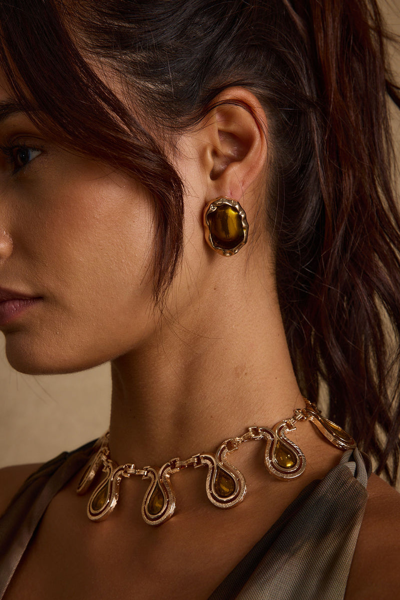 Back view of the gold piece showing the silhouette and fit.