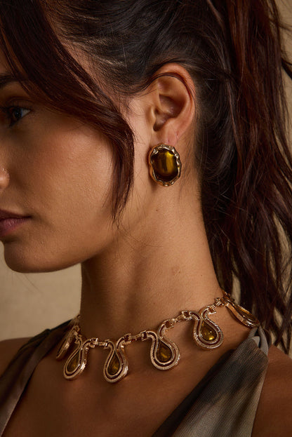 Back view of the gold piece showing the silhouette and fit.